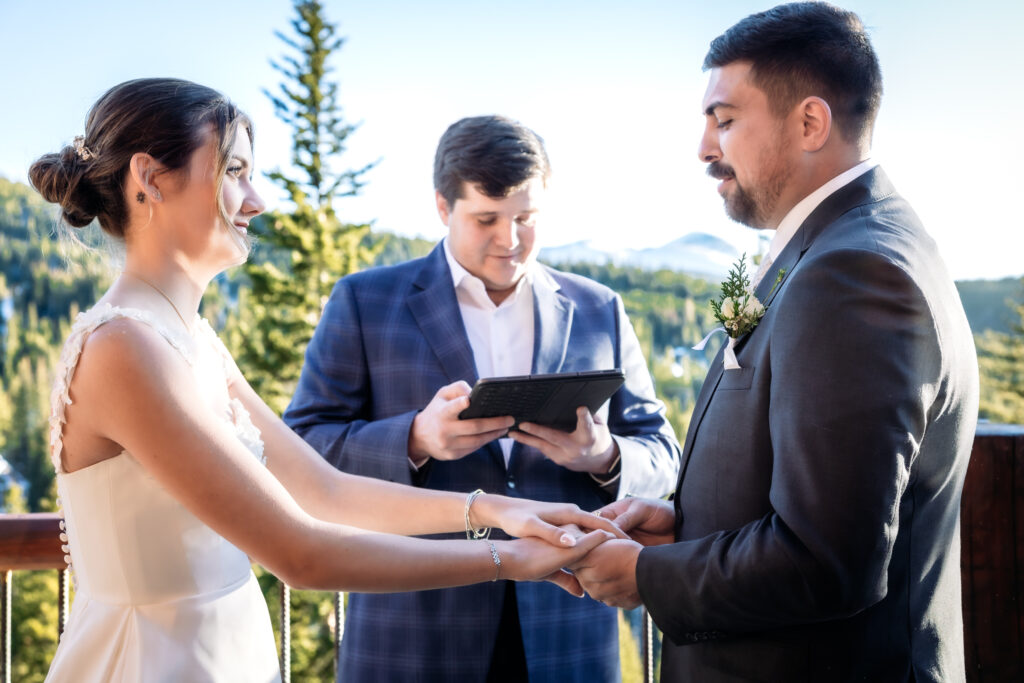 Couple exchanges rings during elopement ceremony.