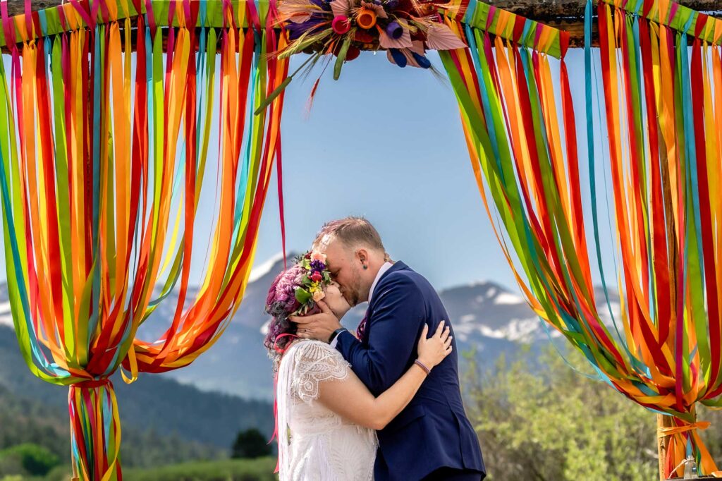 Bride & groom's first kiss with san juan mountain range in the background.