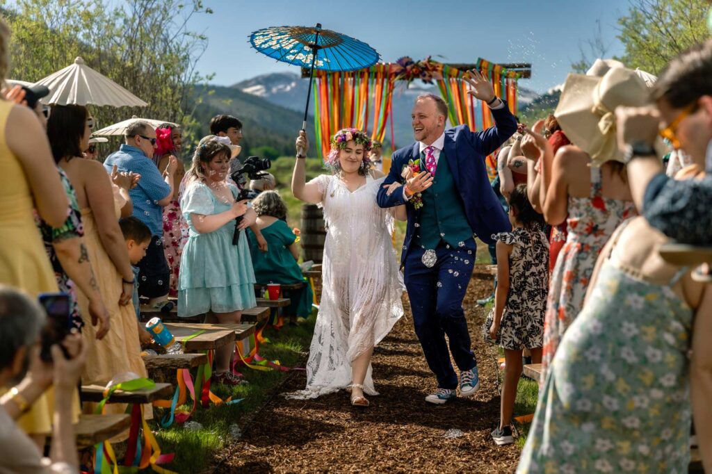 Bride and groom walk down aisle after wedding in Villa Grove Colorado.