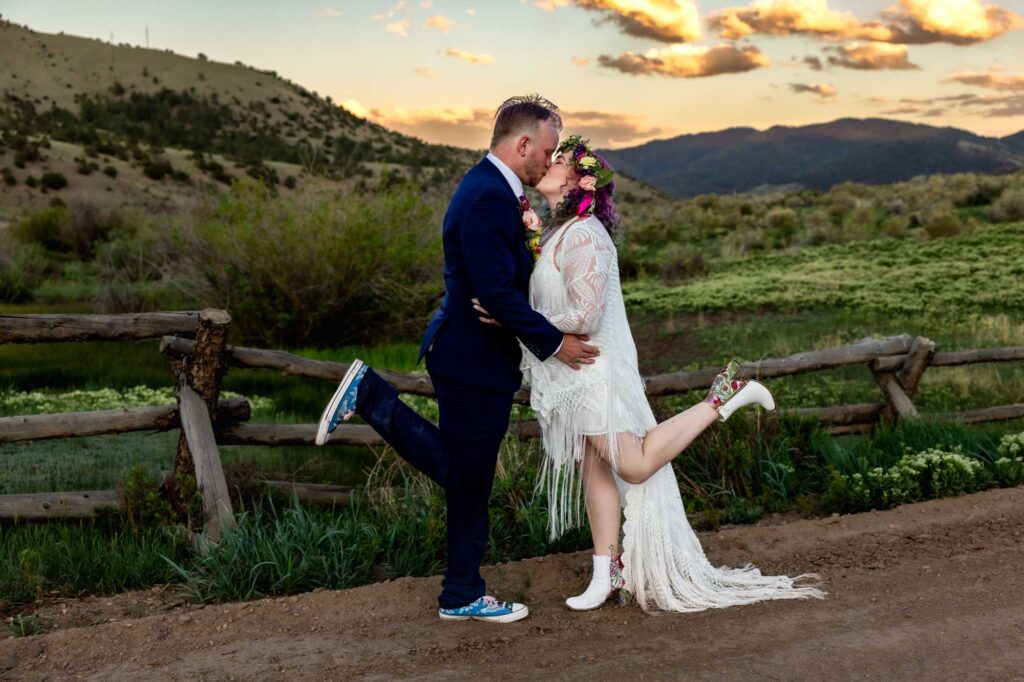 Bride and groom strike a fun pose at sunset after their elopement in the San Juan Mountains in Colorado.