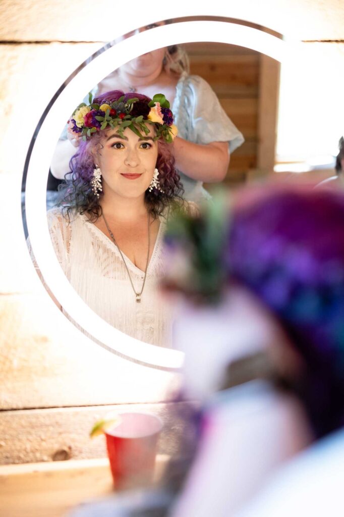 Bride gets ready in the mirror during Salida elopement