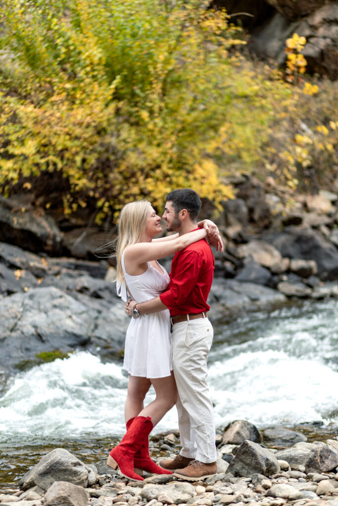 Couples photoshoot in Golden Colorado with intimate moment and river backdrop.