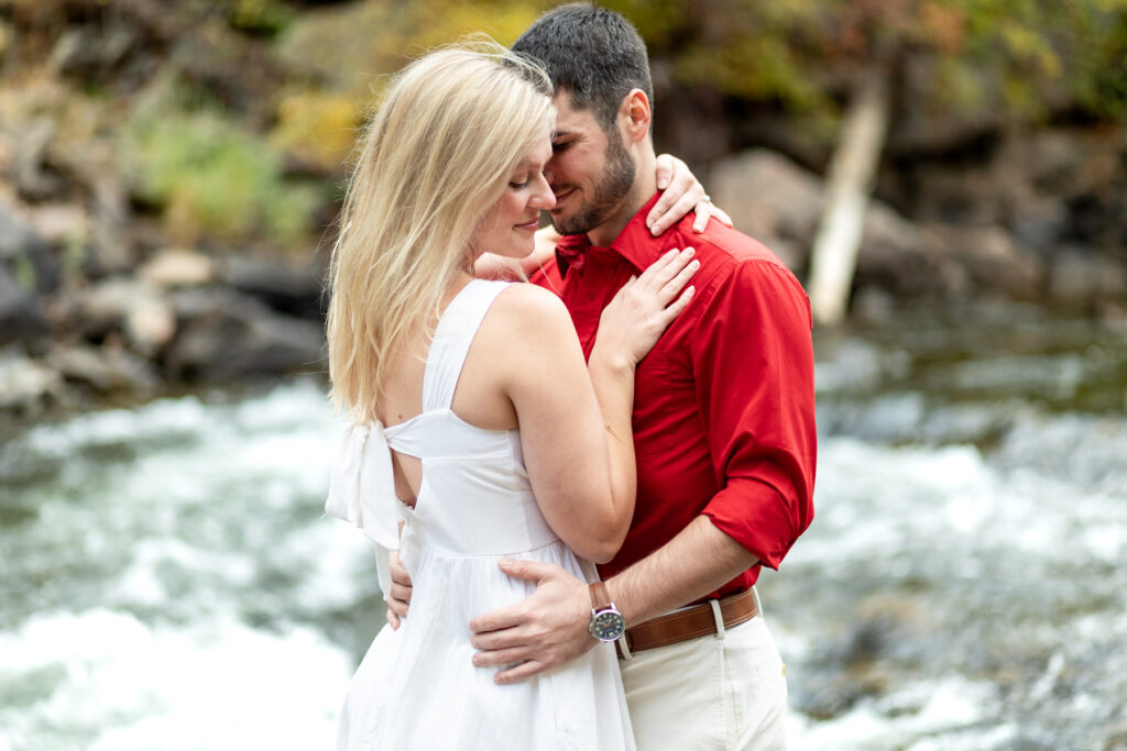 Couples photoshoot in Golden Colorado with intimate moment and river backdrop.