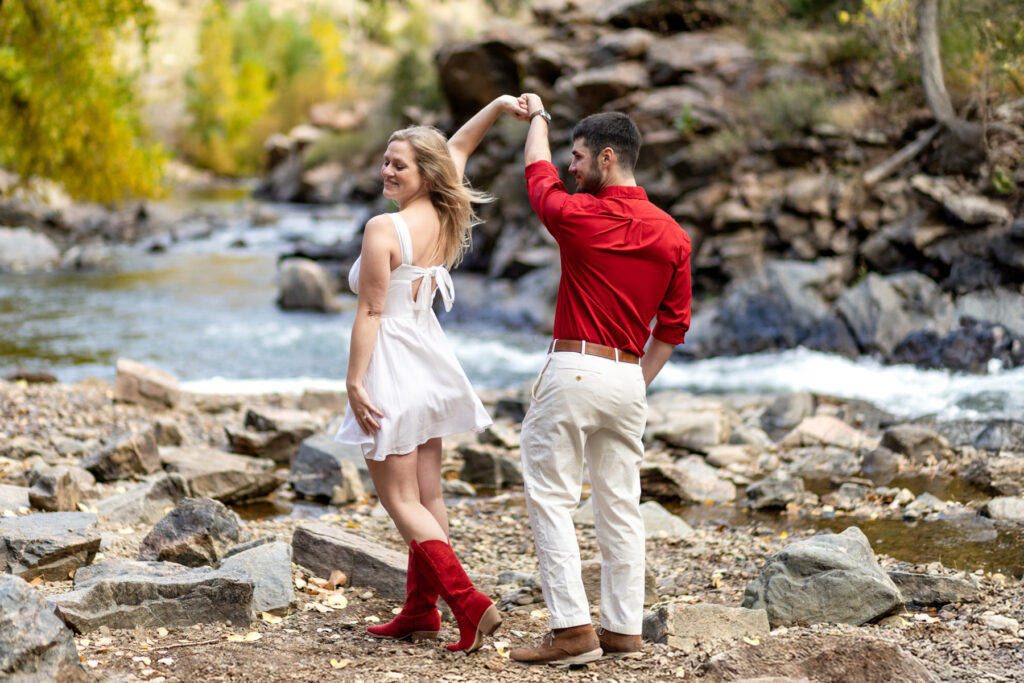 Couples photoshoot in Golden Colorado with intimate moment and river backdrop.