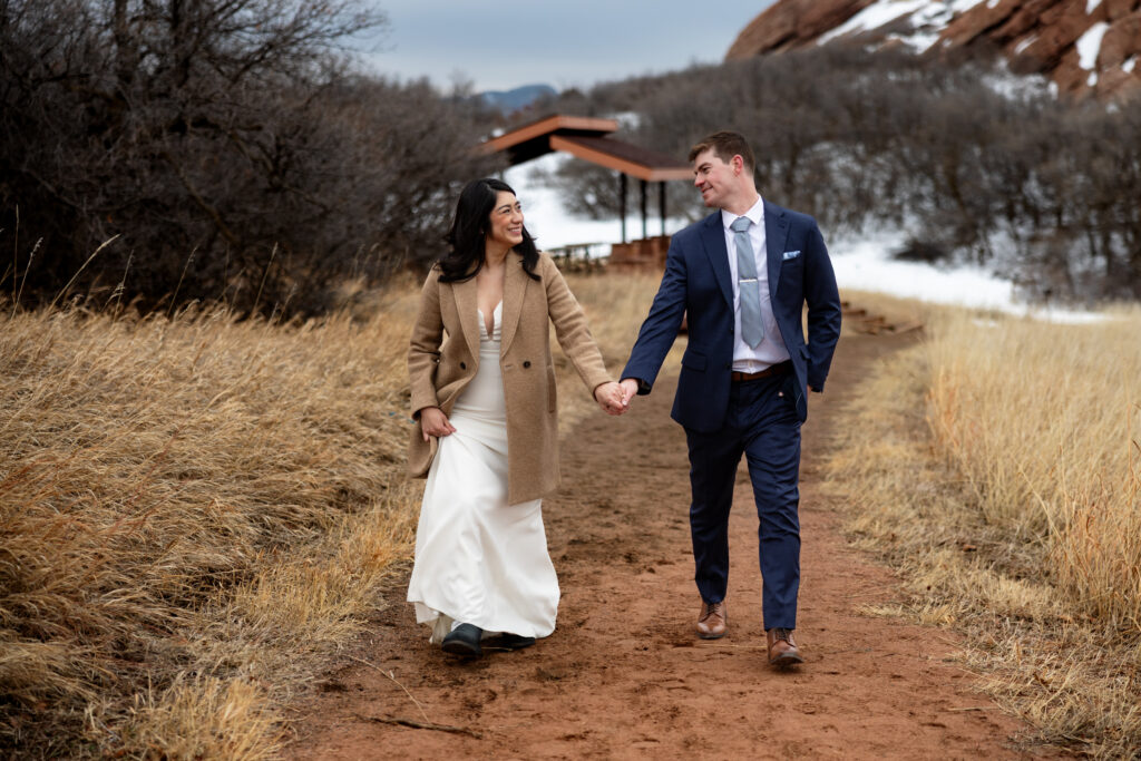 Bride and groom walk together during intimate Colorado winter elopement outside of Denver.
