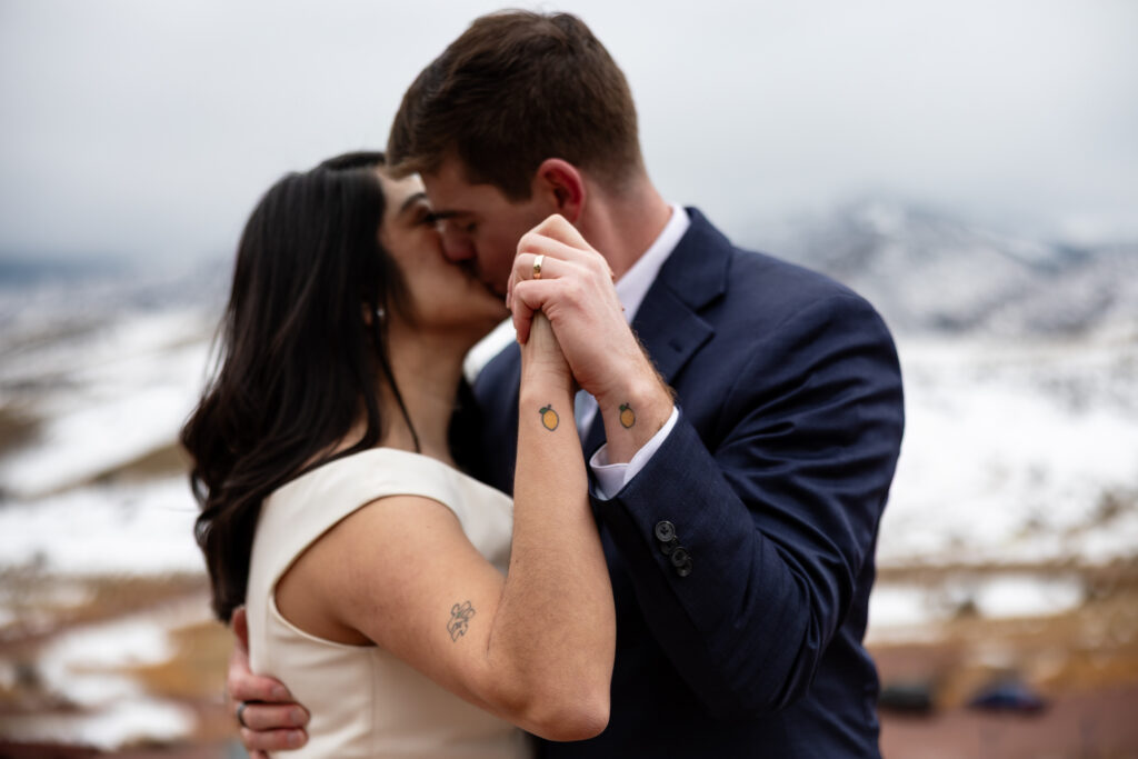 Colorado couple shows off matching tattoos during their first dance at local park during elopement.