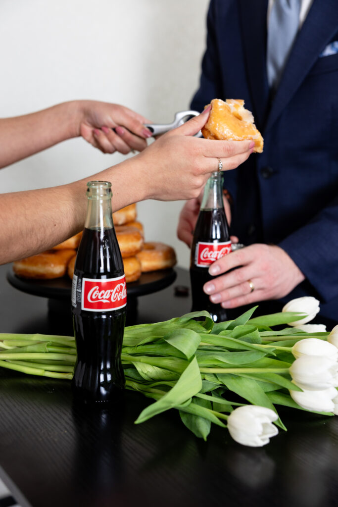 Colorado elopement couple shares donuts and Coca Cola at intimate Airbnb in Denver.