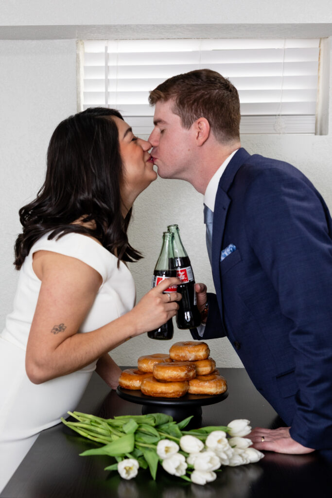 Colorado elopement couple shares Coca Cola at intimate Airbnb in Denver.