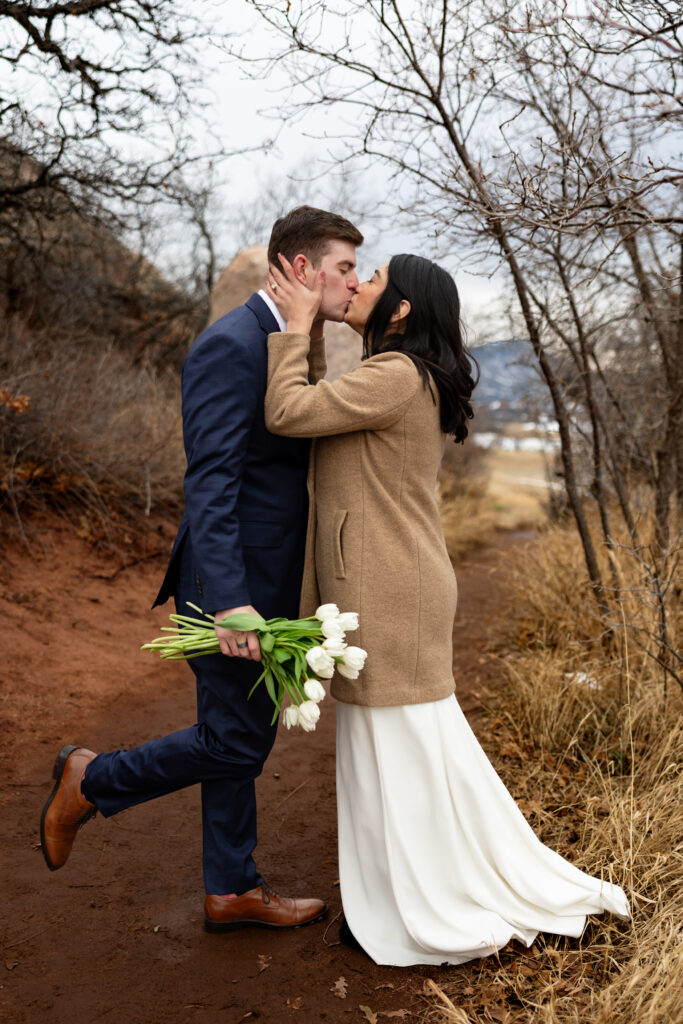 Couple strikes fun pose during their intimate Colorado winter elopement.