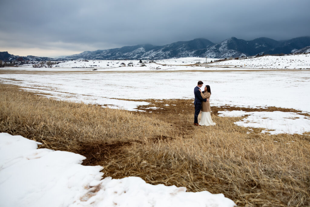 Colorado elopement with couple standing in the snow for portraits.