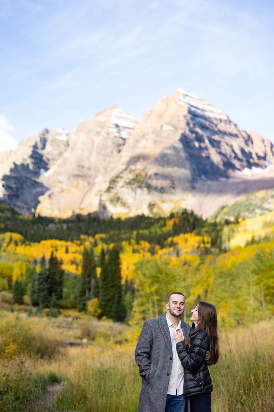 Colorado couple poses in front of Maroon Bells after sunrise proposal