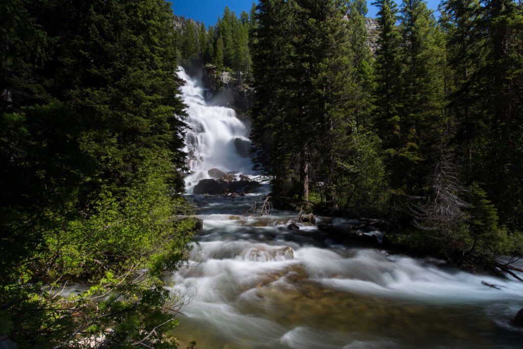 Colorado elopement spot with rushing waterfall and pine trees.
