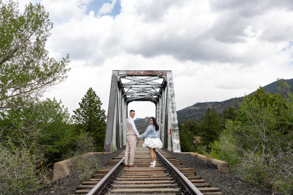 Bride and groom explore train tracks in Buena Vista during their Colorado elopement