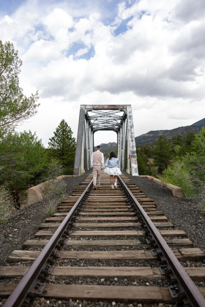 Couple explores train tracks in Buena Vista during their Colorado elopement.
