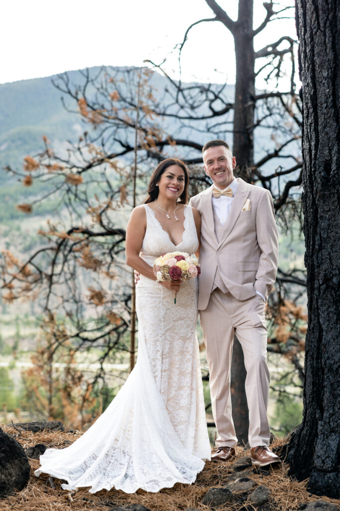 Bride and groom posing on a private property during their Colorado ranch elopement.