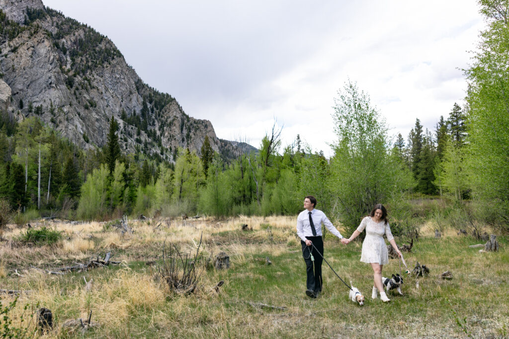 Bride wears short white dress and boots for the first part of her Colorado mountain elopement.