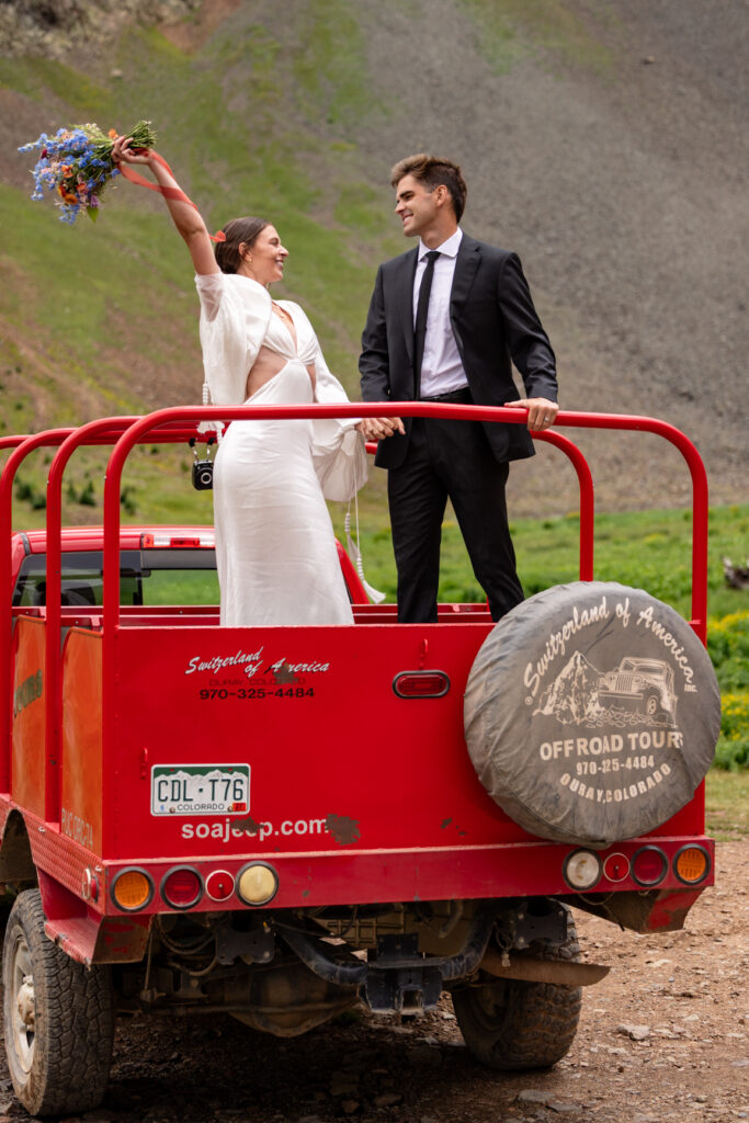 Couple off roading in the mountains during their Colorado elopement