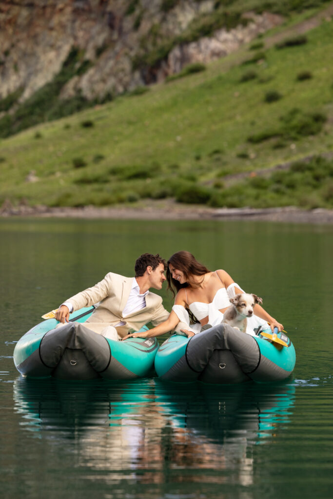 Couple kayaking with dog on a mountain lake during their Colorado elopement