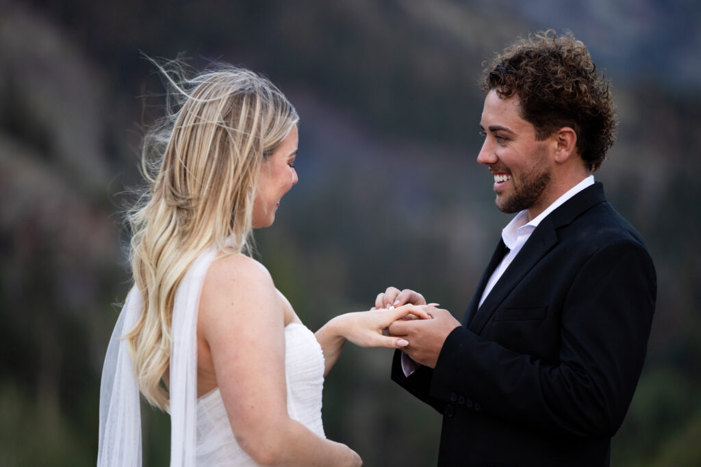 Couple exchanges rings during Colorado elopement wedding ceremony