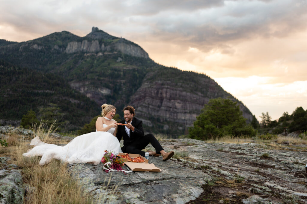 Newlyweds having a picnic during their Colorado mountain elopement