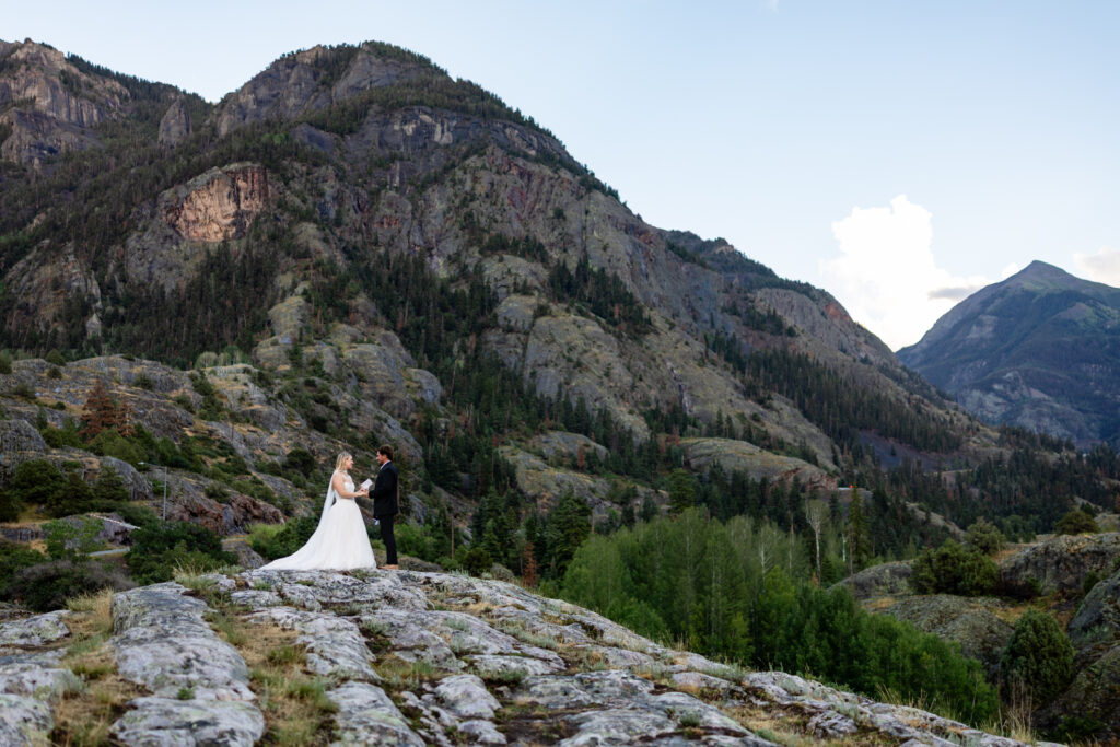 Newlyweds watching the sunset during their full day Colorado elopement