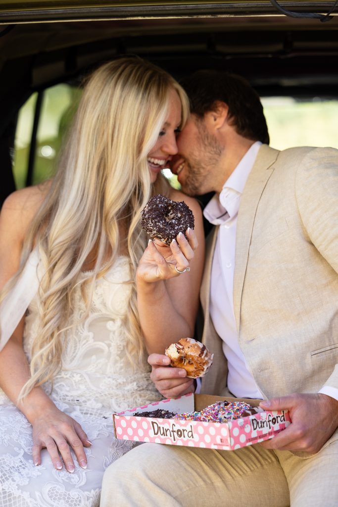 bride and groom share donuts and coffee during their sunrise crested butte elopement