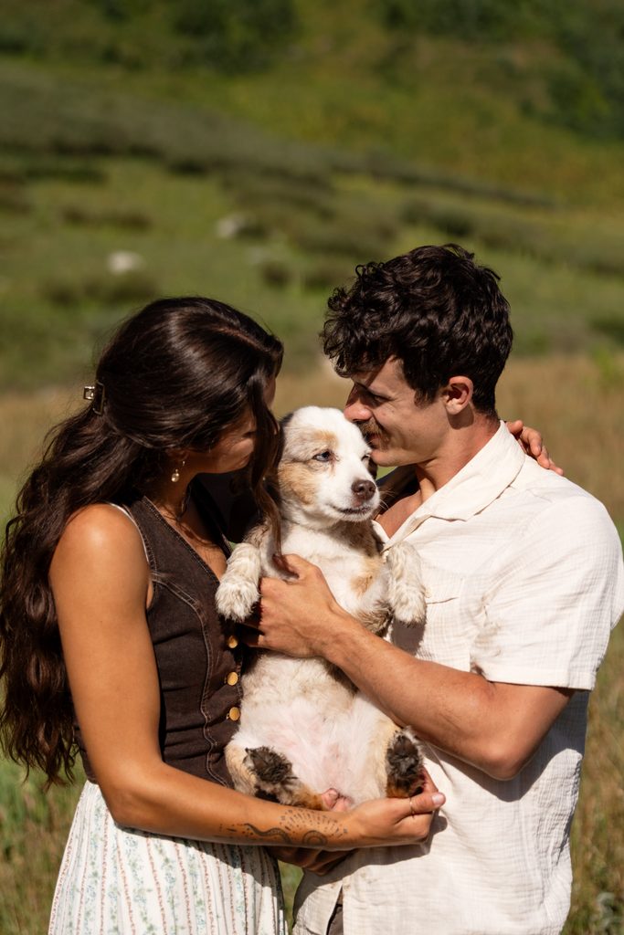 bride and groom hug dog at sunrise Crested Butte elopement