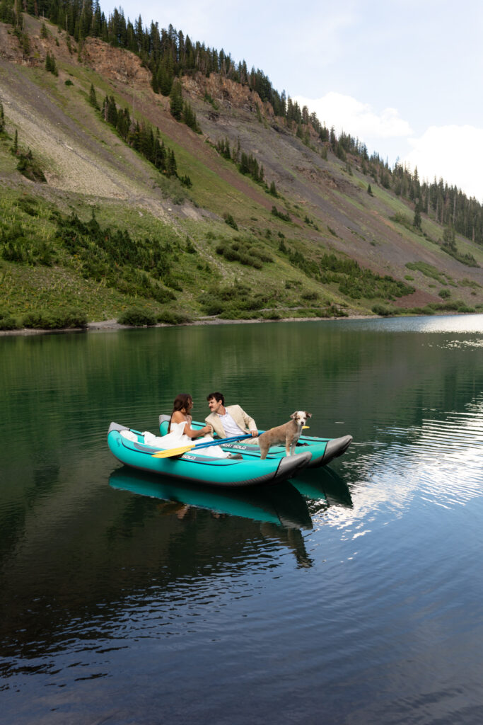 bride and groom kayak with dog during crested butte elopement