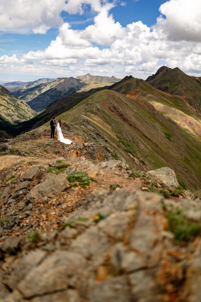 Couple exchanging vows at California Pass overlooking Lake Como in Colorado