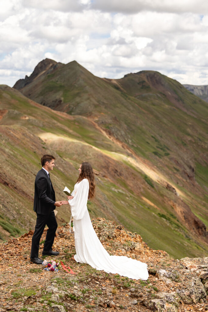 Couple exchanging vows at California Pass  in ouray elopement