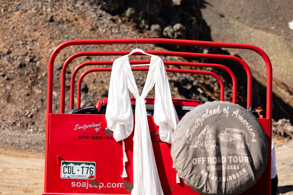 Bridal details hang on a jeep at Ouray elopement